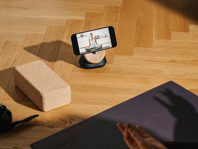 High quality yoga blocks and straps on wooden floor.