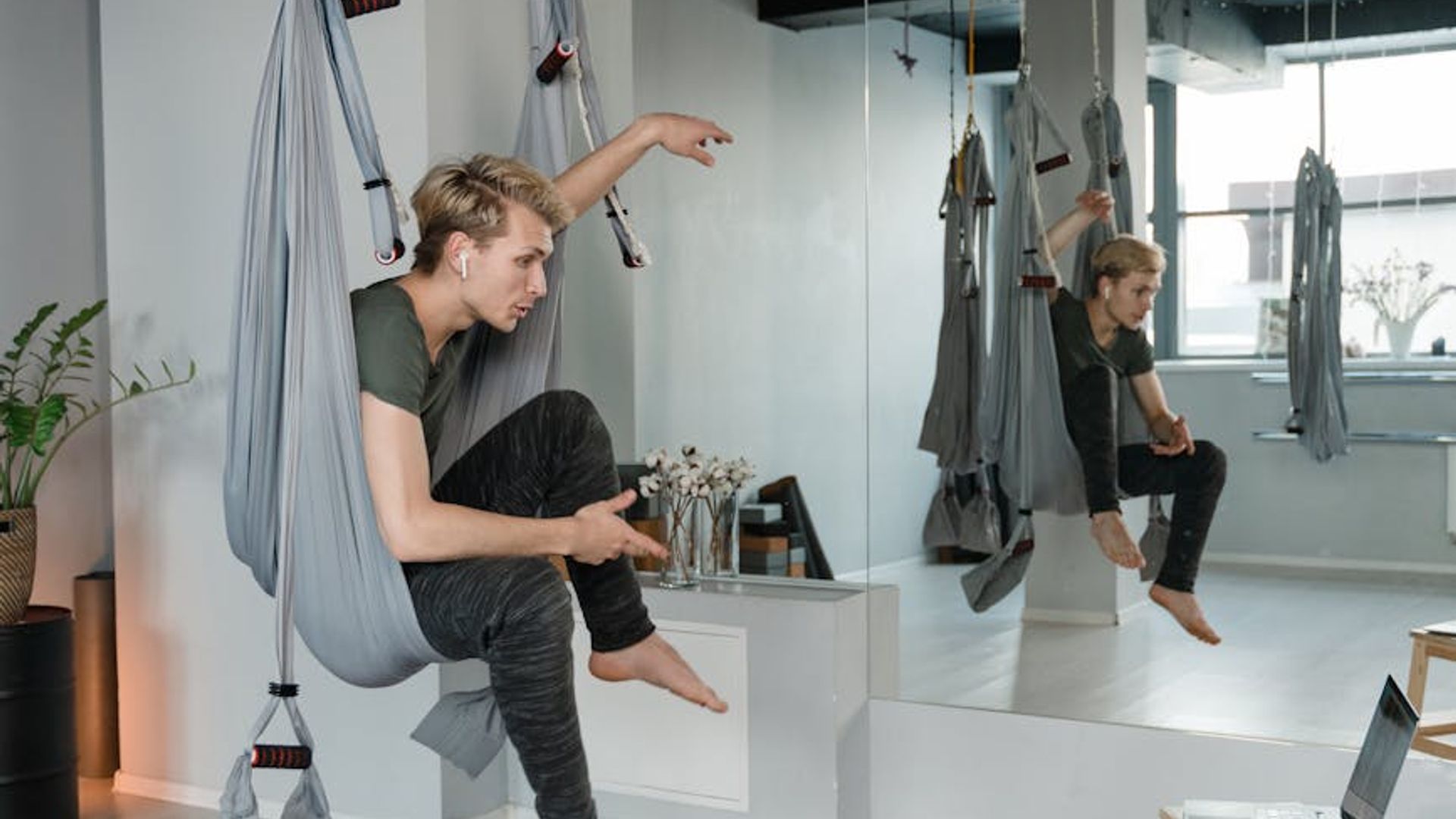 Minimalist yoga studio with warm light and wooden floor.